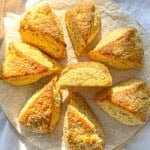 Buttermilk scones on a parchment paper line cutting board.