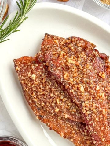 Maple pecan bacon on a white oval platter.