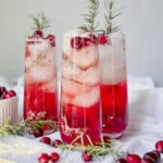 Cranberry mocktails with fresh cranberries and sprigs of rosemary.