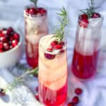 Cranberry mocktails with fresh cranberries and sprigs of rosemary.