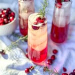 Cranberry mocktails with fresh cranberries and sprigs of rosemary.