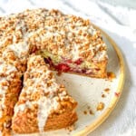Side view of a sliced mixed berry sour cream coffee cake.