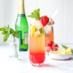 Strawberry lemonade mimosa mocktail on a white background.