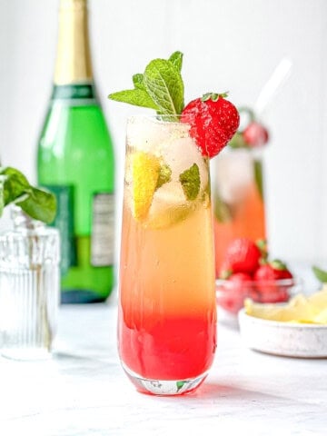 Strawberry lemonade mimosa mocktail on a white background.