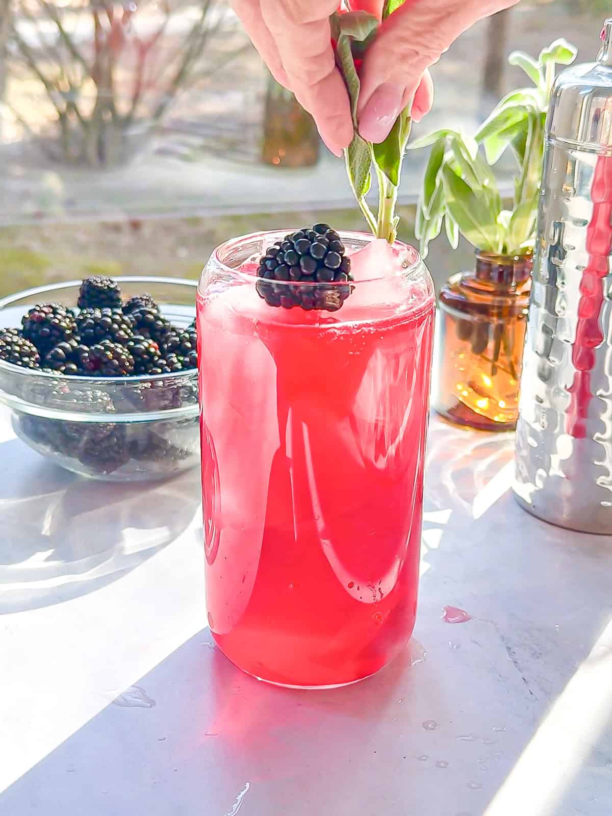 Adding a sprig of sage to a blackberry sage refresher.