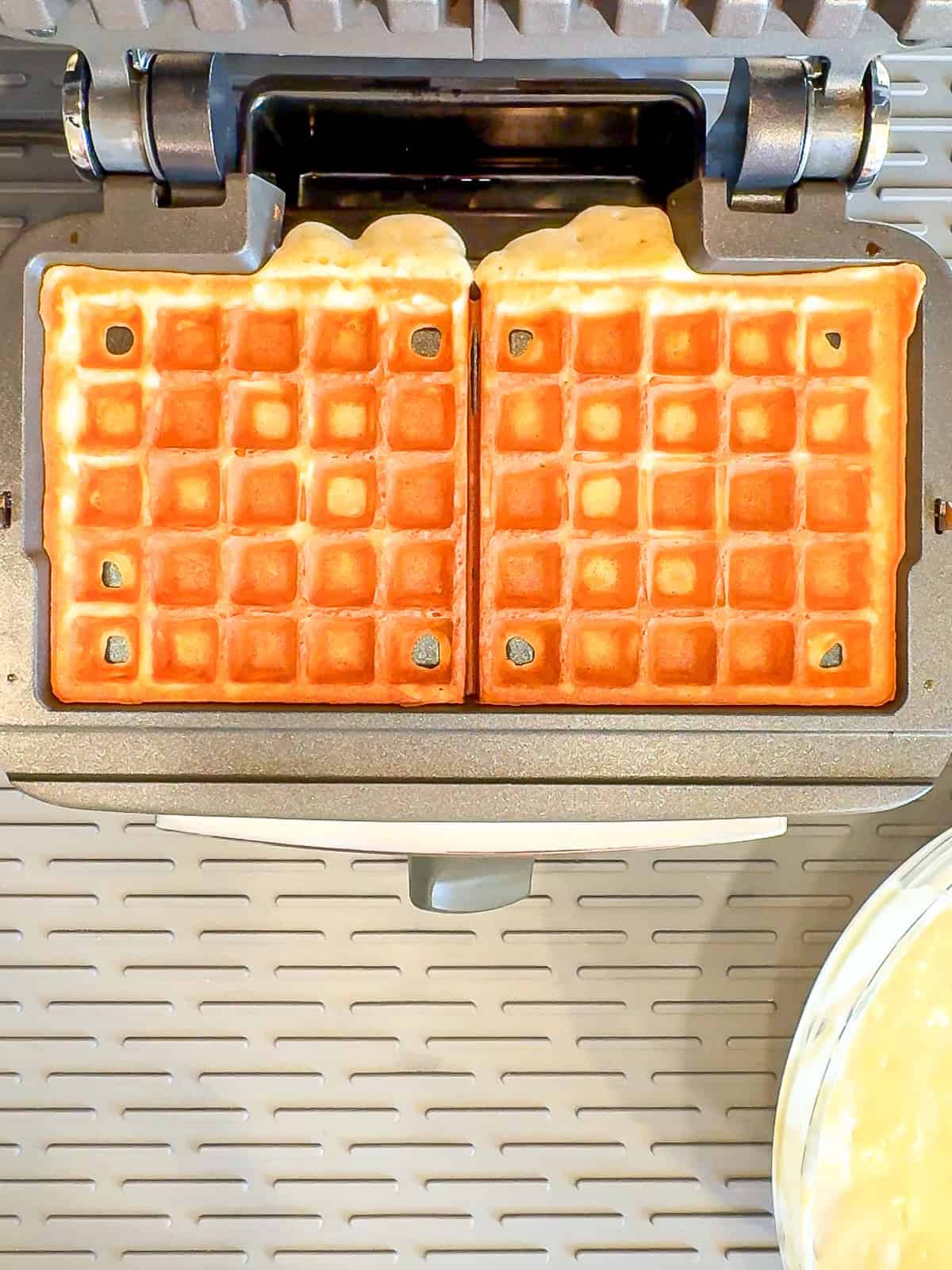 Cooked waffles in a waffle maker.