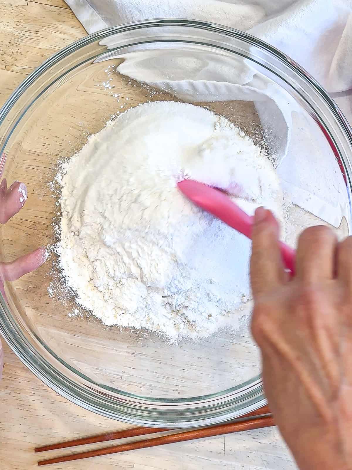 Stirring together dry ingredients for a waffle batter.