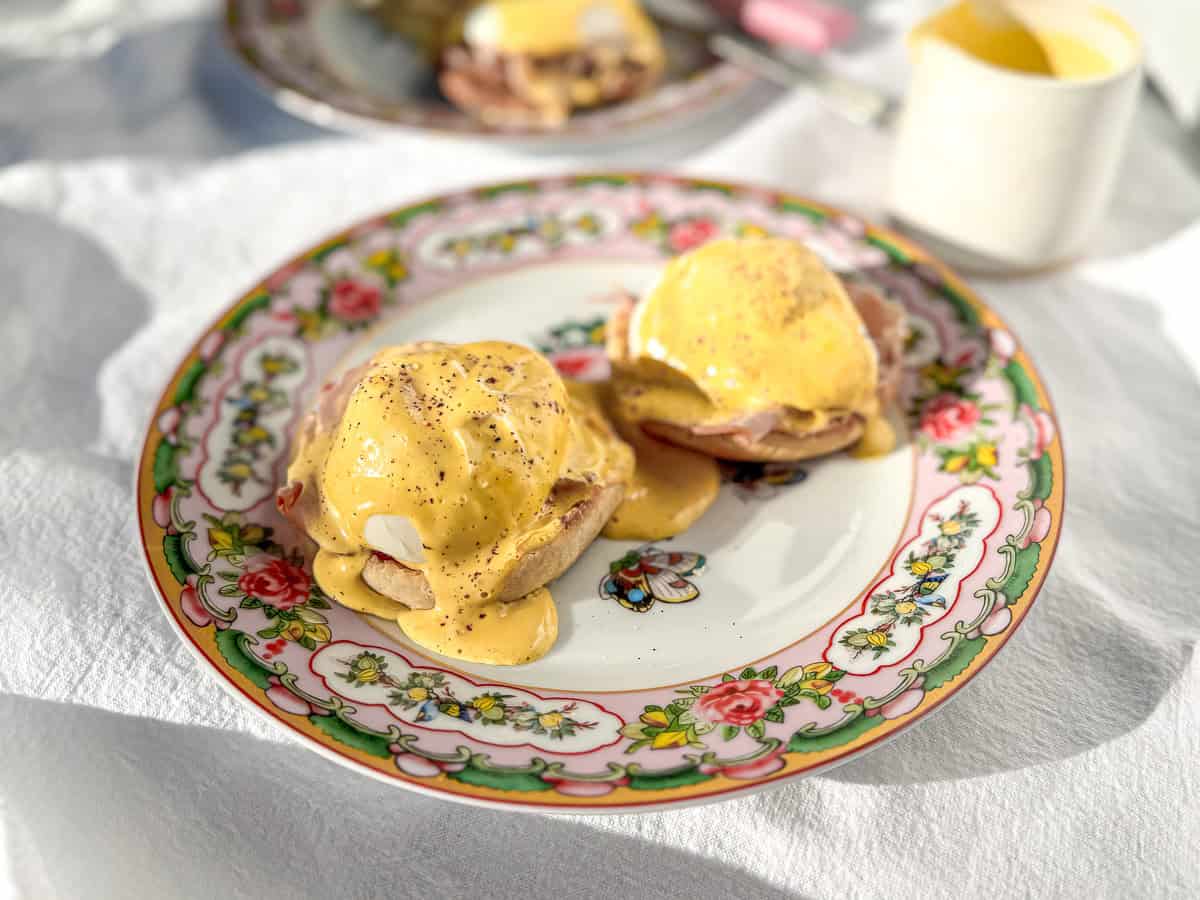 Side view image of egg Benedict with hollandaise sauce.