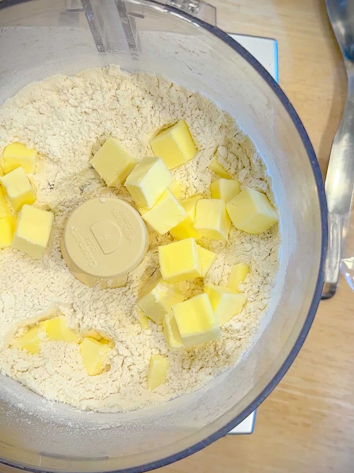 Dry ingredients and cold cubed butter and a food processor to make pie dough.