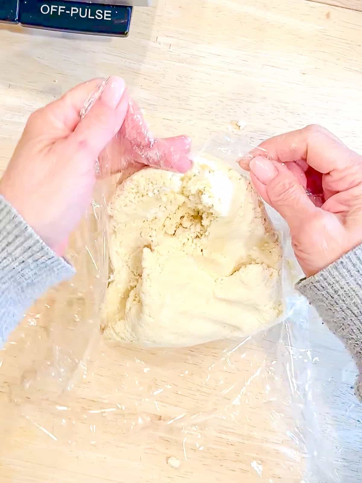 Wrapping pie dough in plastic.