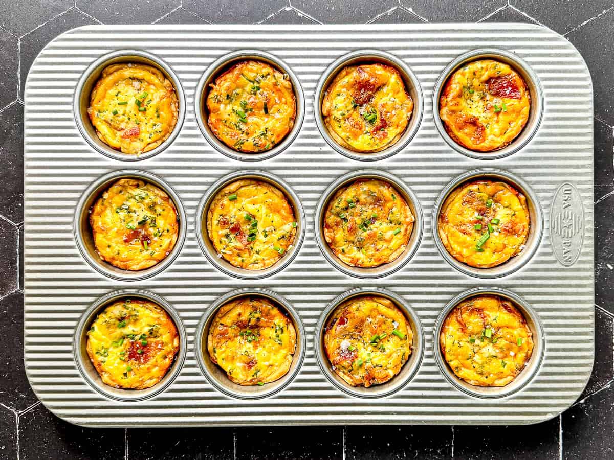 Mini quiche Lorraine in a muffin pan.