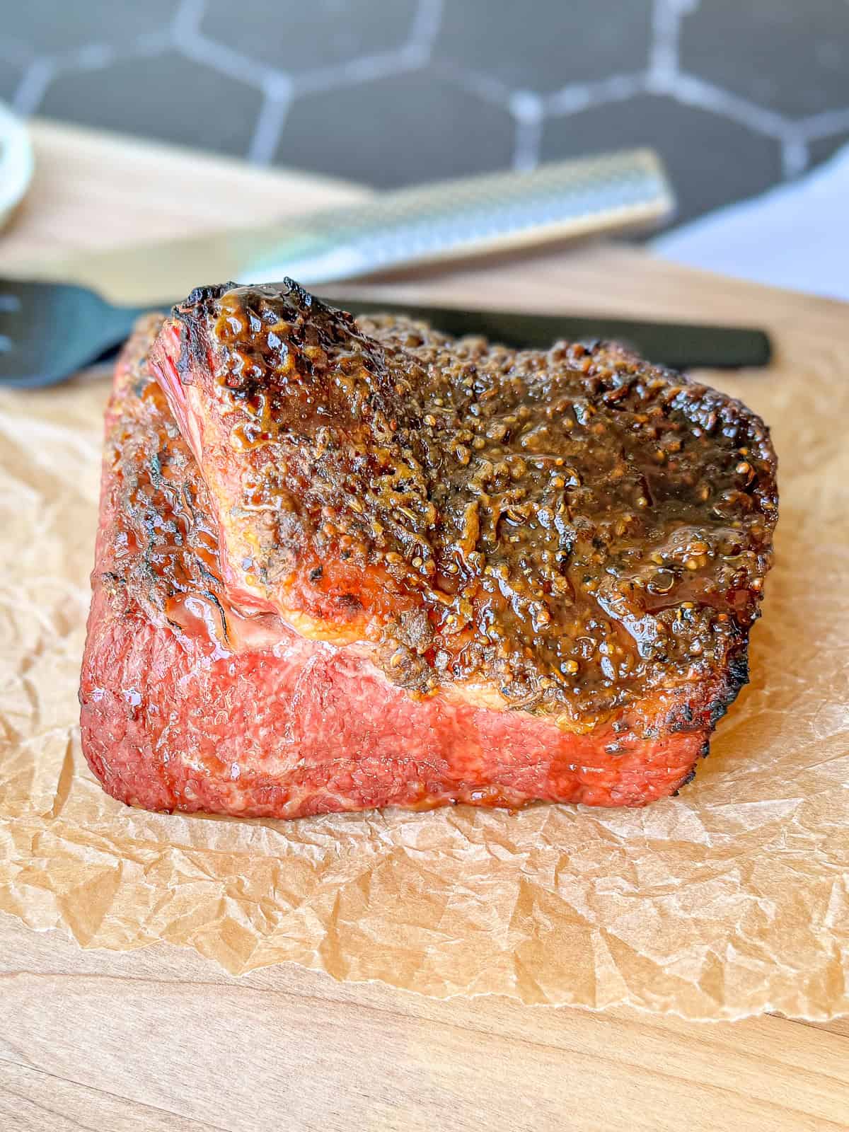 Corned beef on a wood wooden cutting board.