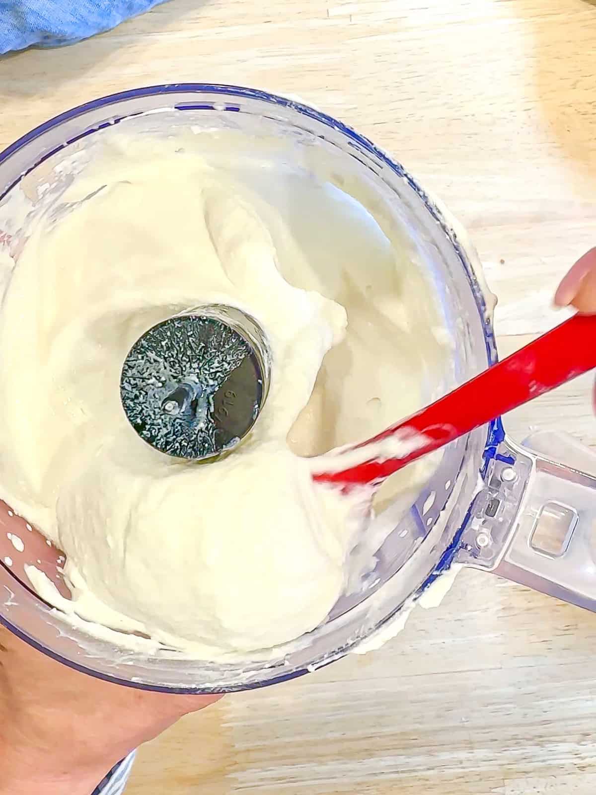 Blending cottage cheese in a small food processor.