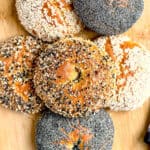 A stack of cottage cheese bagels with various toppings; sesame seeds, poppy seeds, and everything bagel seasoning.