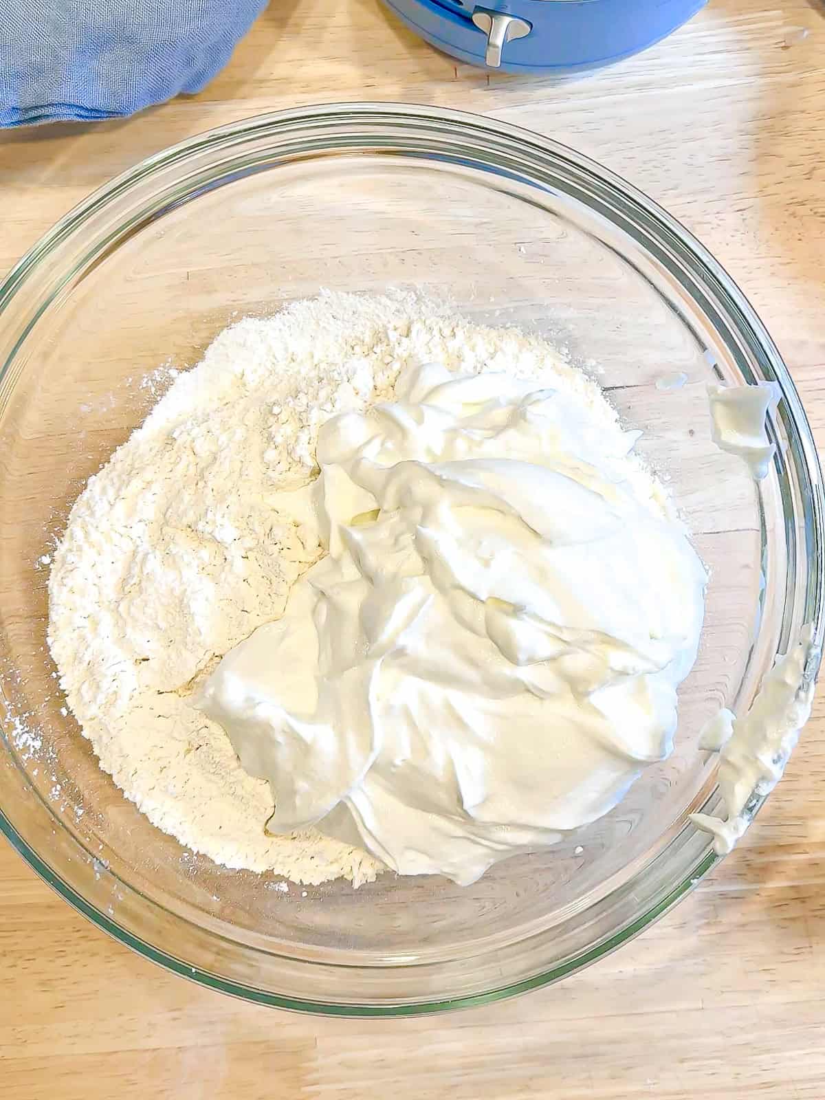 Adding blended cottage cheese to self rising flour to make cottage cheese bagels.