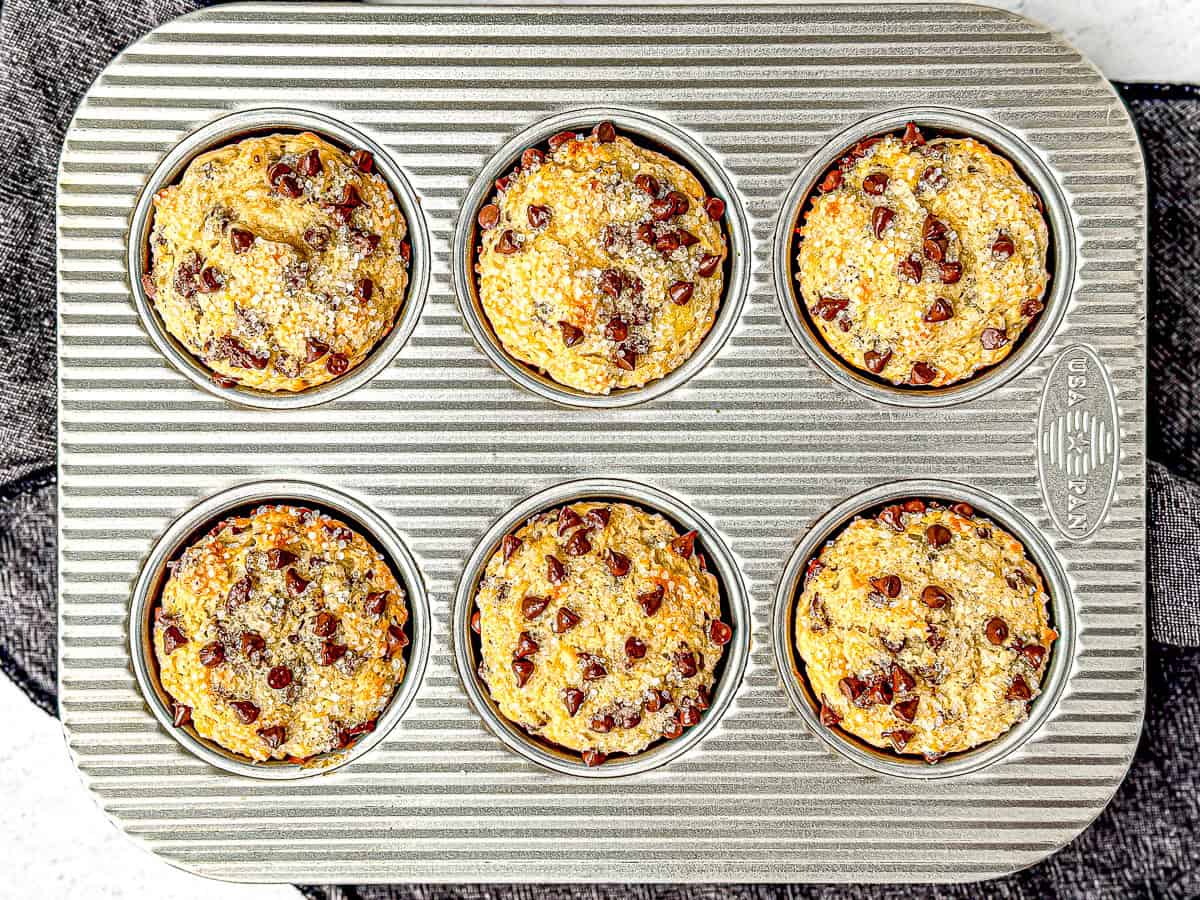 A six well muffin pan filled with four ingredient eggless banana muffins.