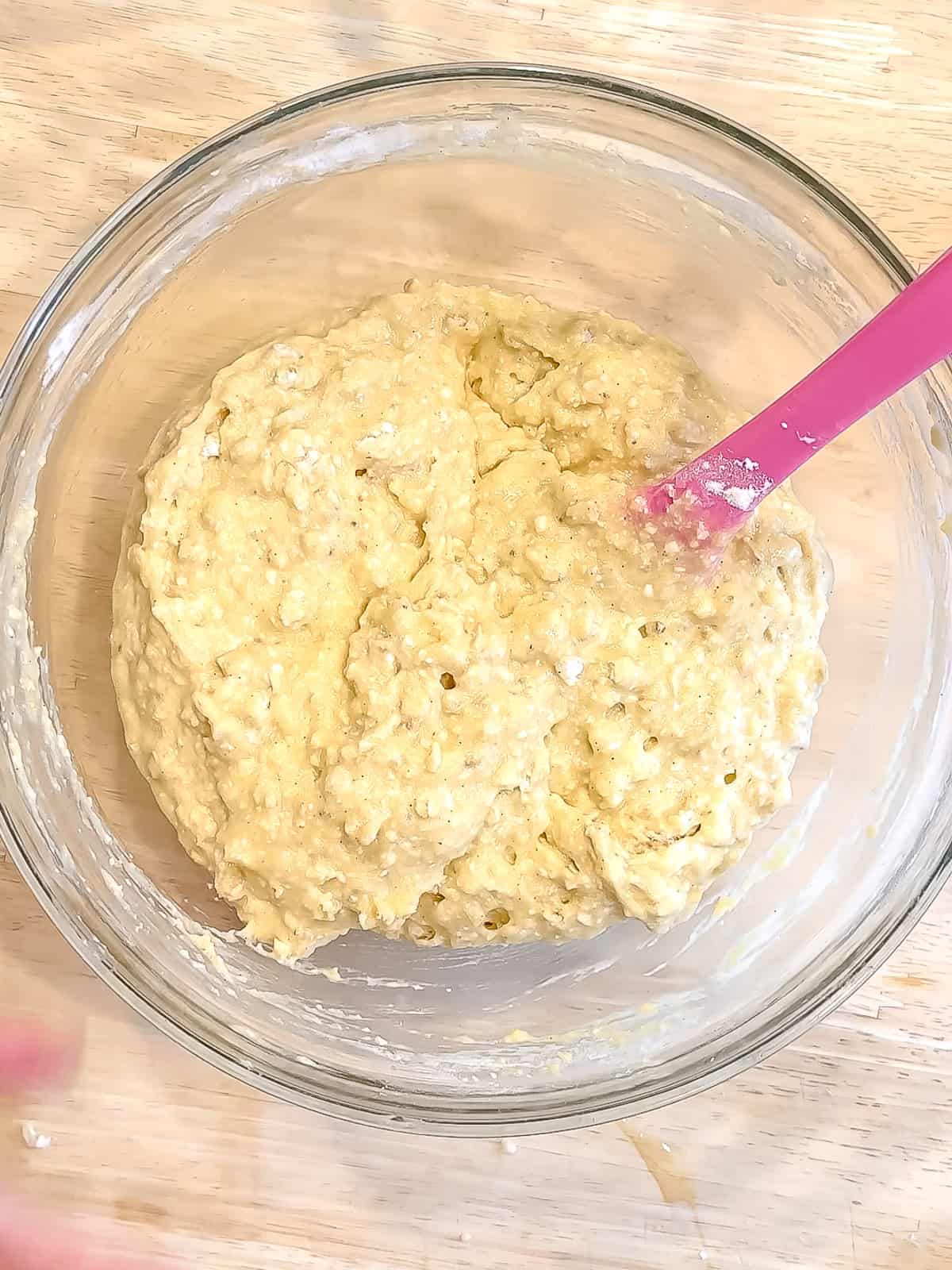 Banana breakfast cake batter in a glass bowl.