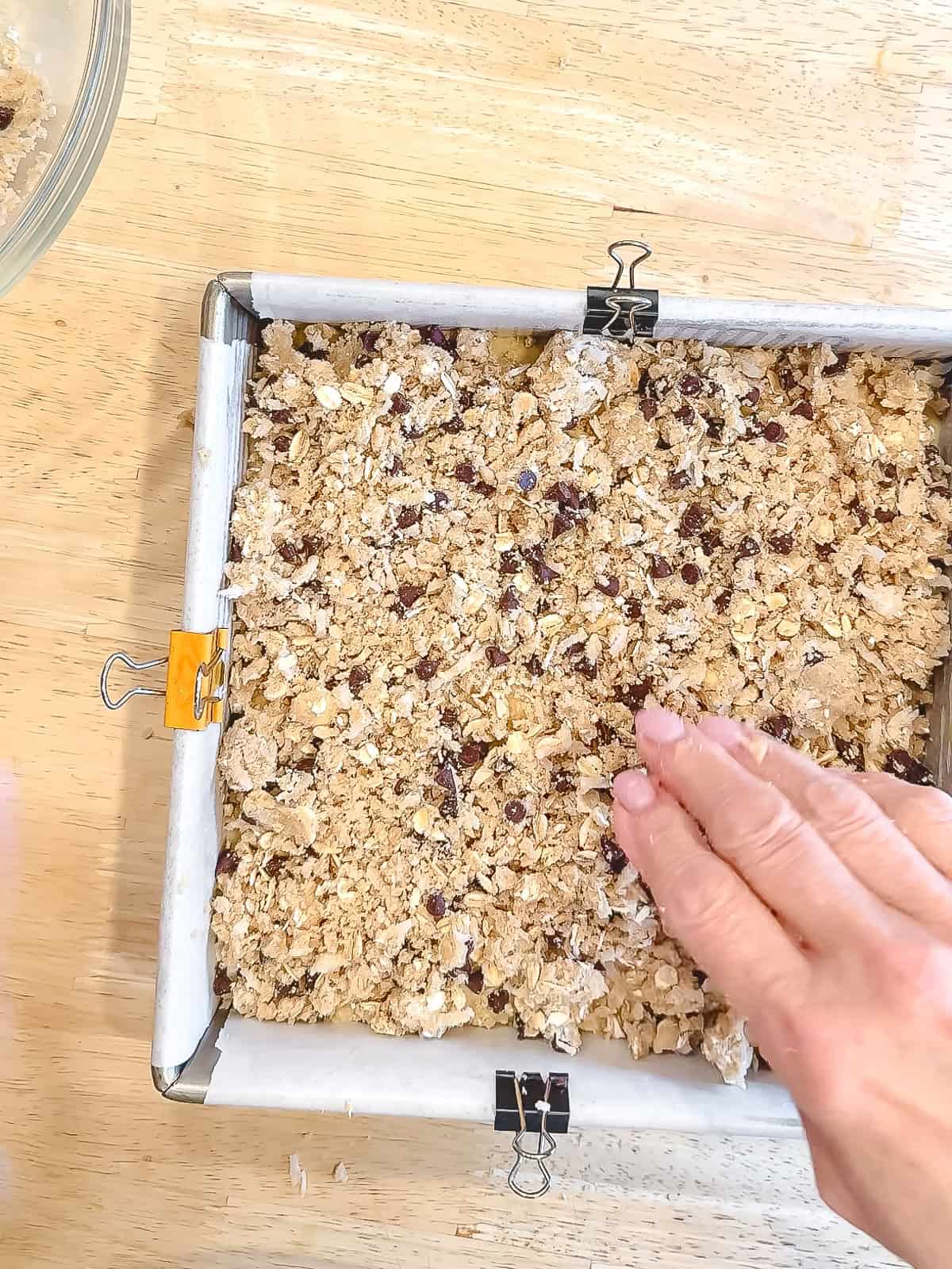 Adding streusel on top of banana breakfast cake.