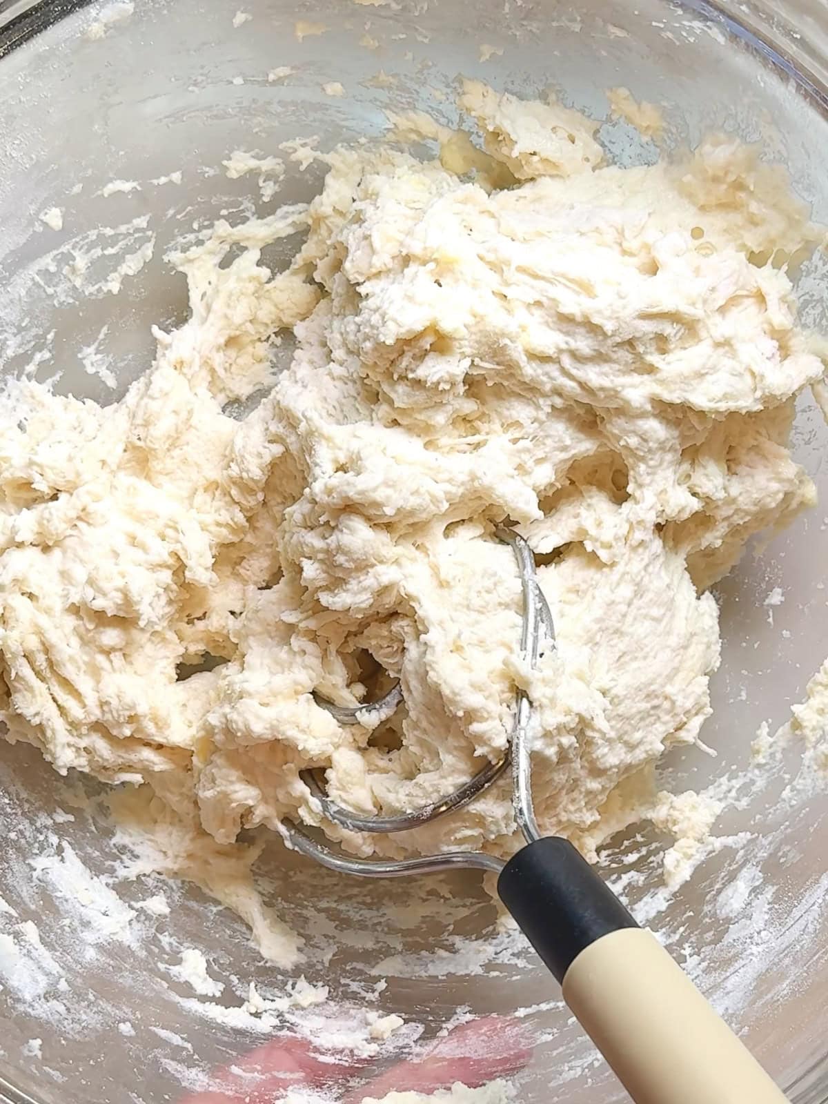 No knead dough with incorporated butter in a glass bowl after intial mixing.