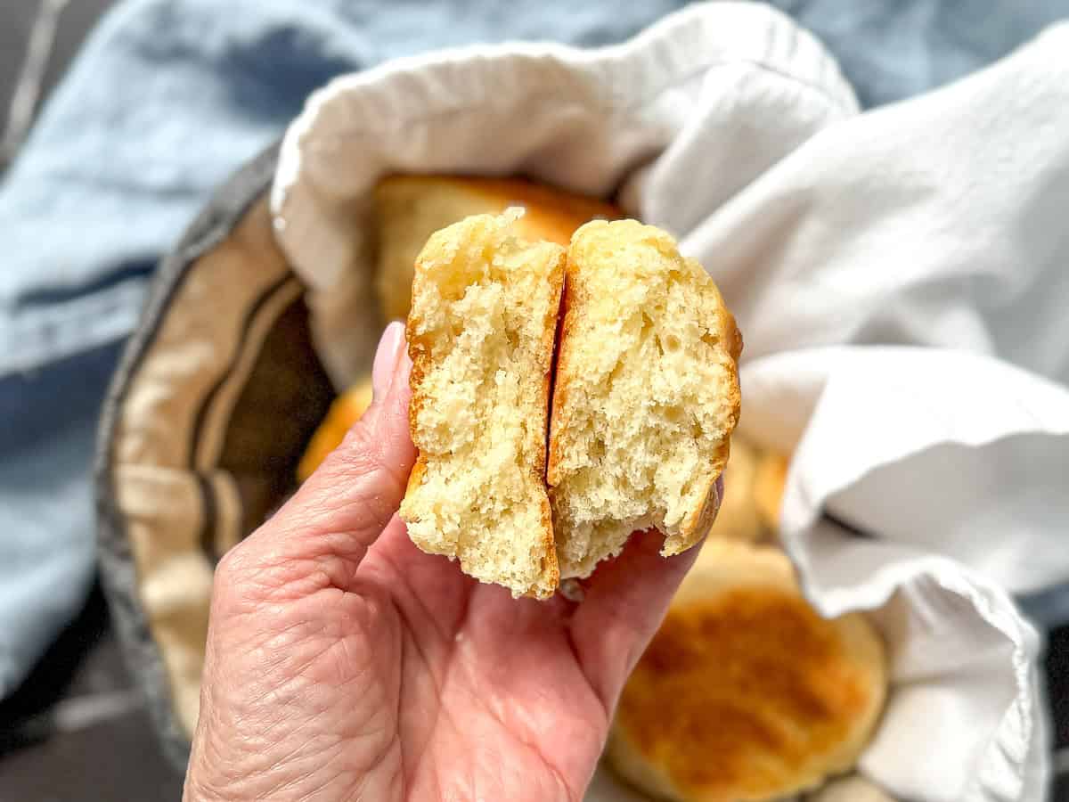 Author's hand holding a broken open biscuit.