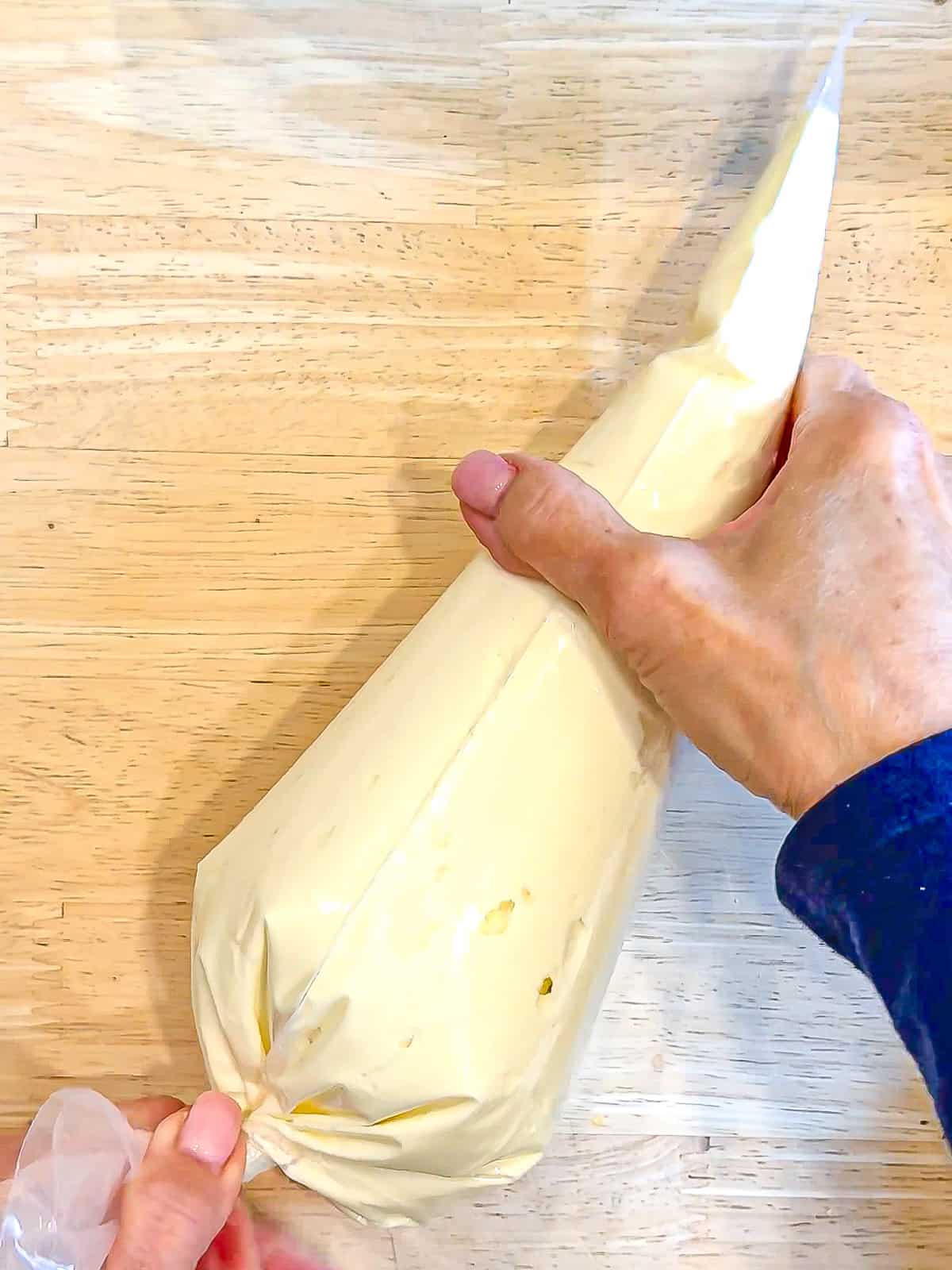 Cheesecake filling in a piping bag.