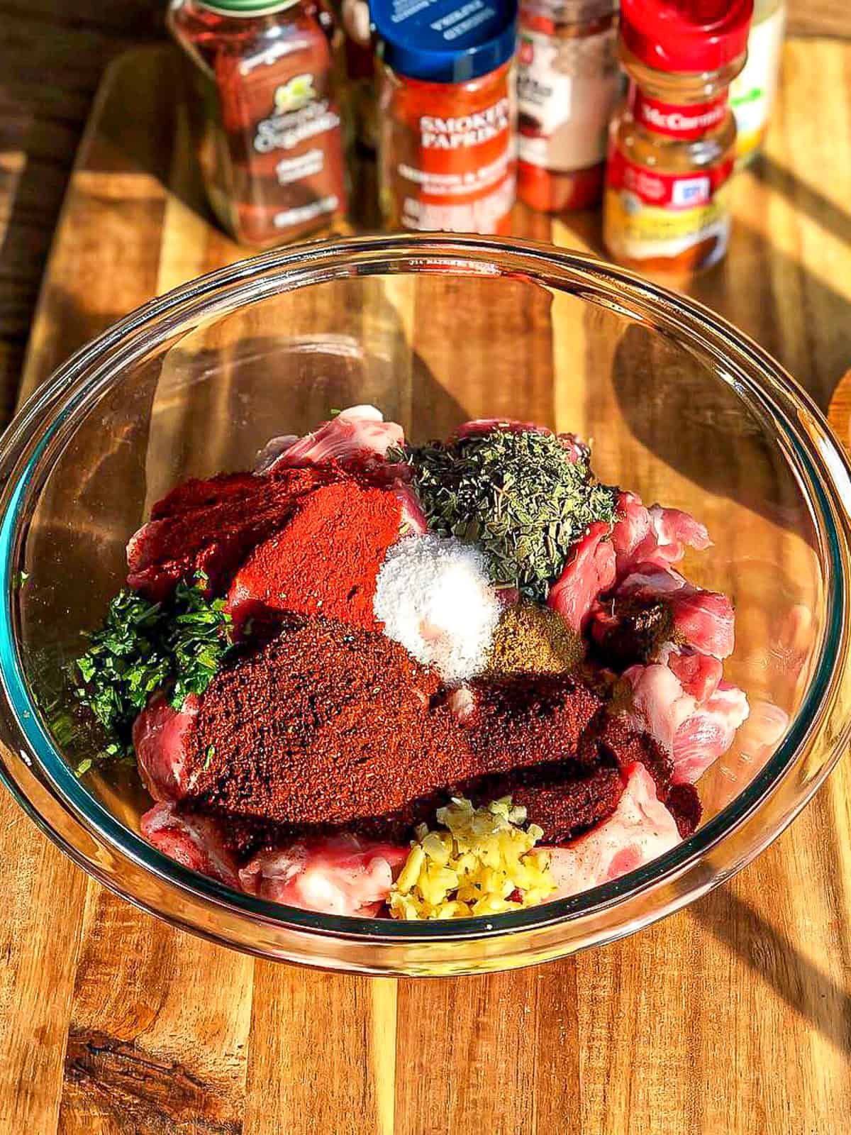 Ingredients needed to make homemade Mexican chorizo in a glass bowl.