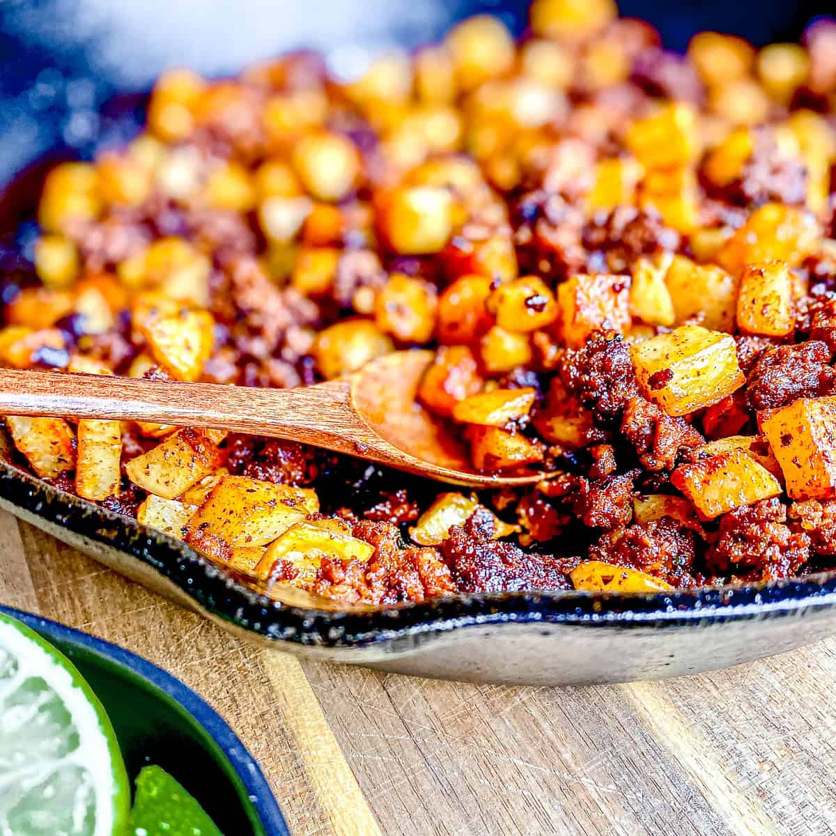 Homemade chorizo and potatoes in a cast-iron pan.