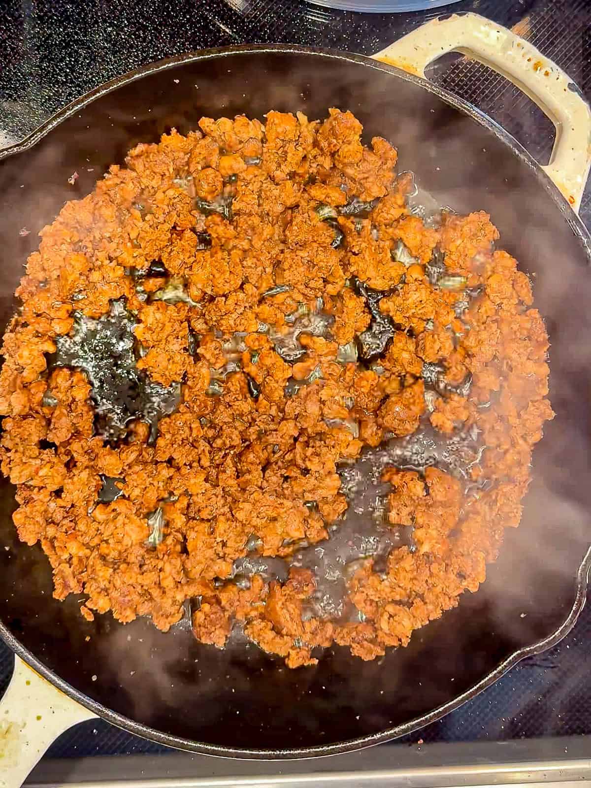 Cooked chorizo in a cast iron pan.