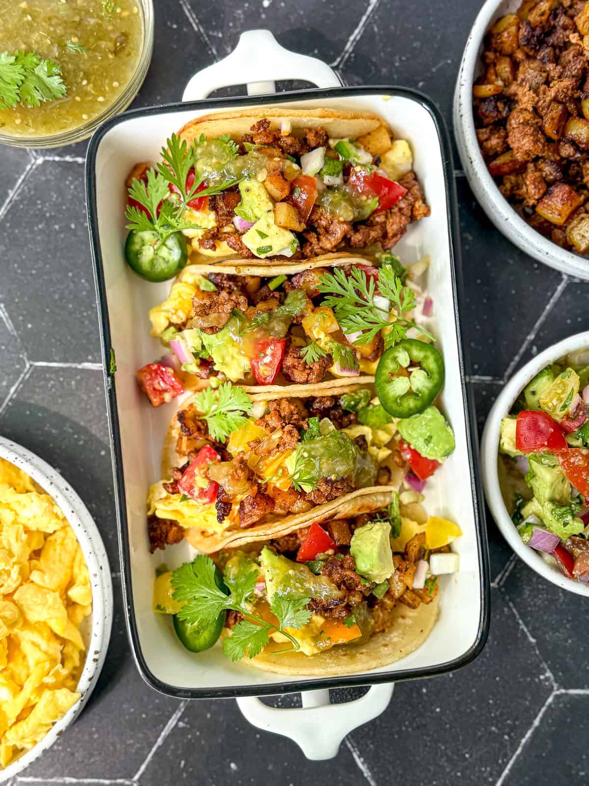 Chorizo and potato tacos in a white ceramic dish