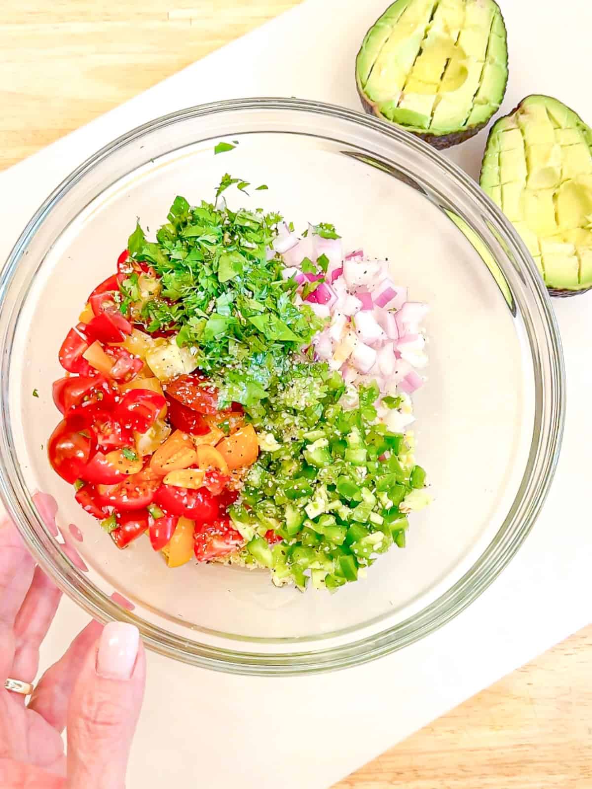 Ingredients for pico de gallo in a glass bowl.