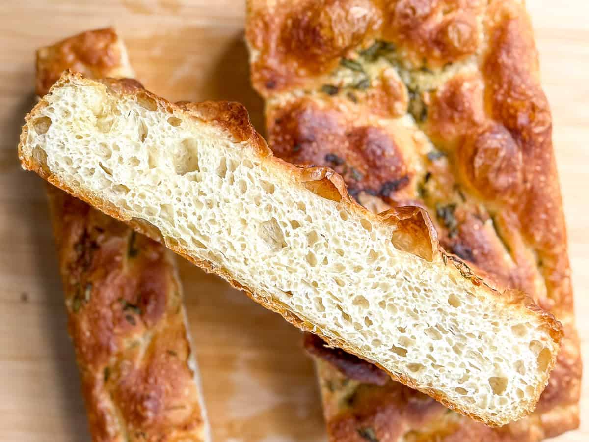 Focaccia on a wooden cutting board.