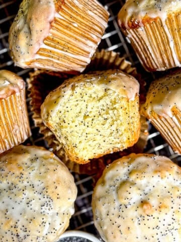 Lemon poppy seed muffins on a wire rack.