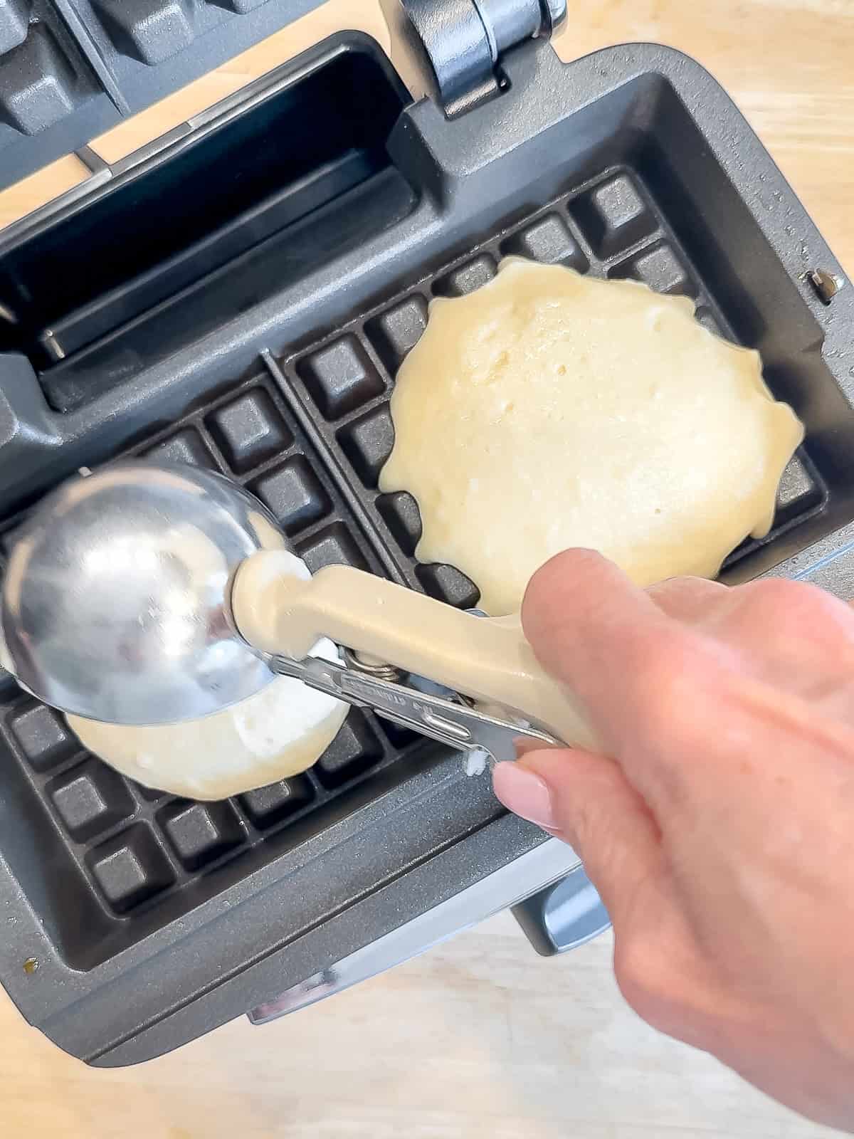 Scooping mochi waffle batter into a waffle maker.