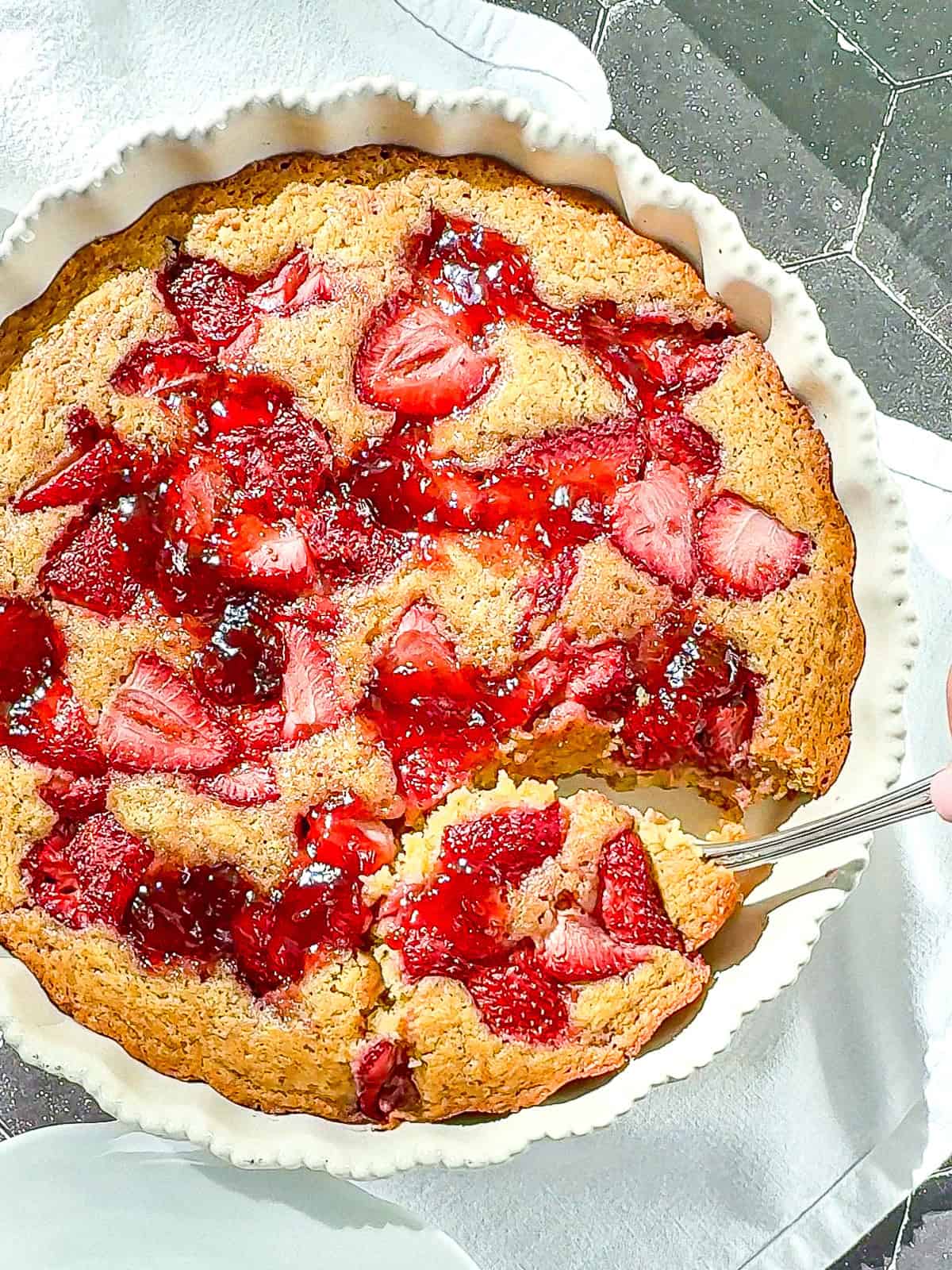 Strawberry cake in a white dish.