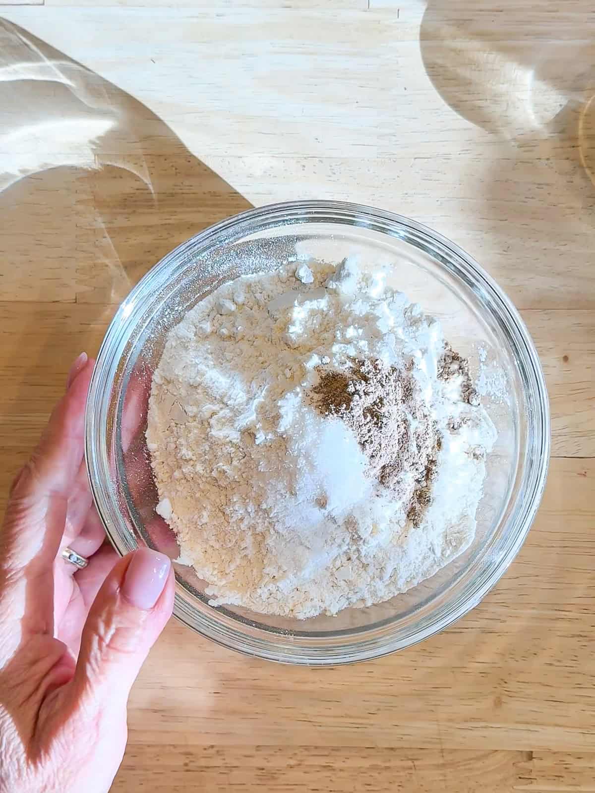 Dry ingredients for cake in a glass bowl.