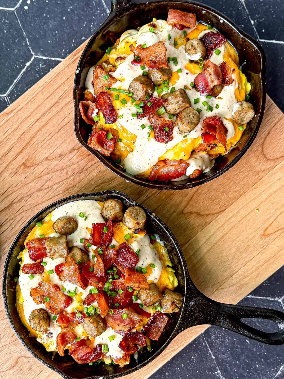 Tater tots with gravy and cheese in mini cast iron pans.