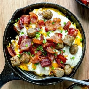 Tater tots with gravy and cheese in mini cast iron pans.