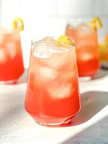 Three aperol spritz in glasses.