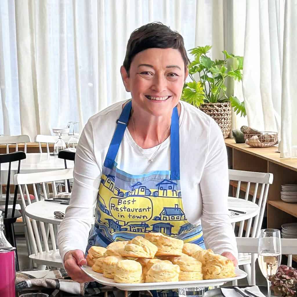 Cynthia holding a tray of biscuits.