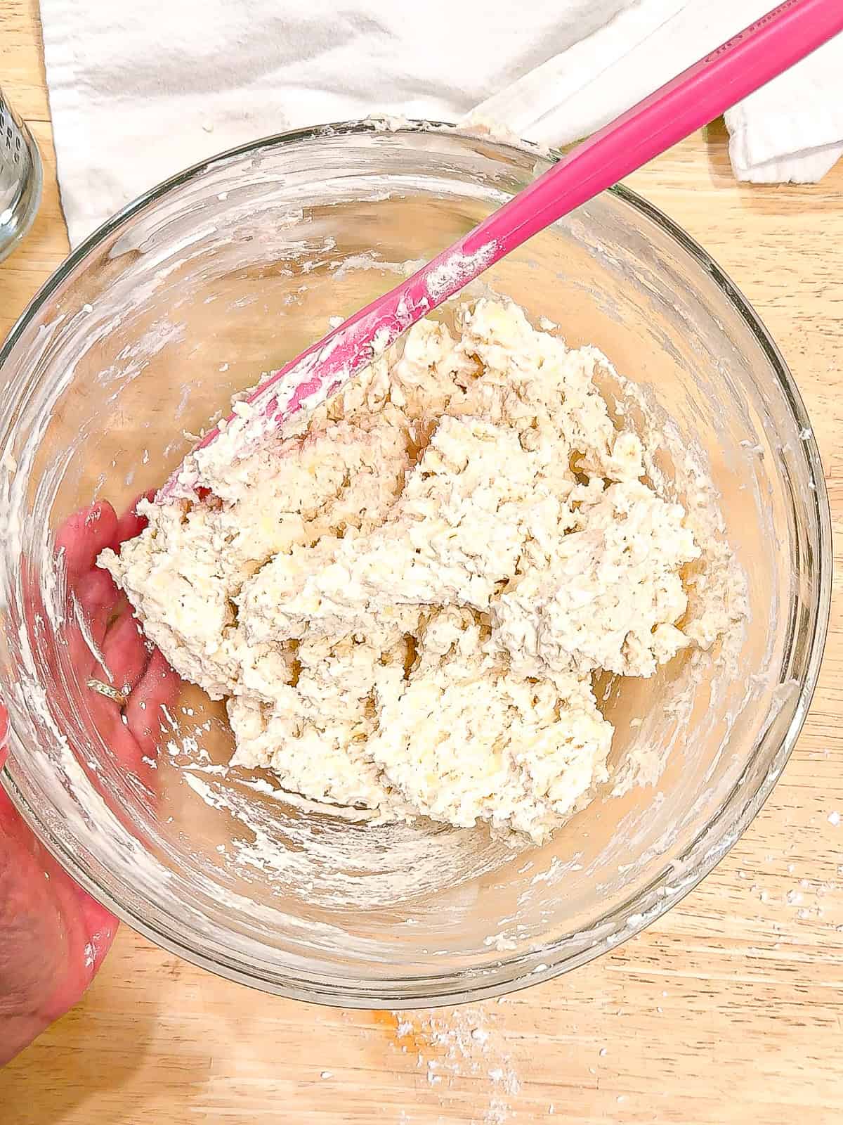 Mixed biscuit dough in a glass bowl.