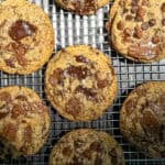 Triple chocolate chip cookies on a wire rack.