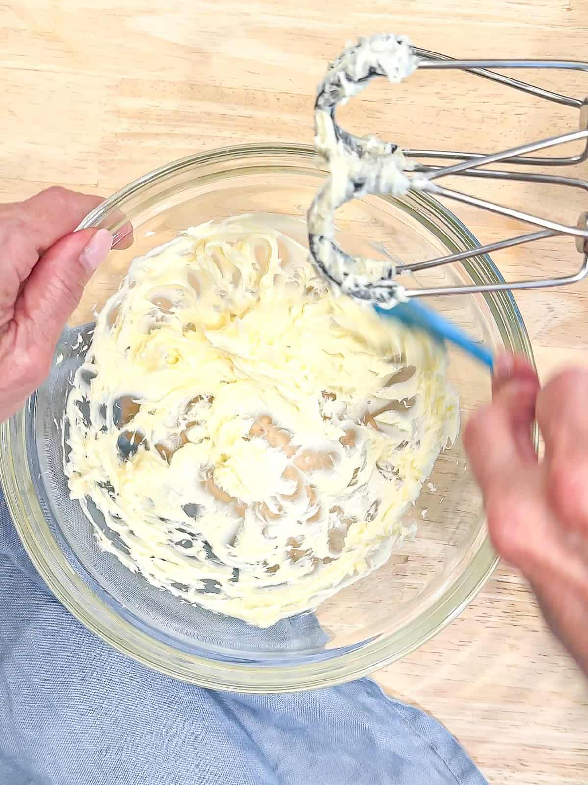 Creaming butter to make buttercream.