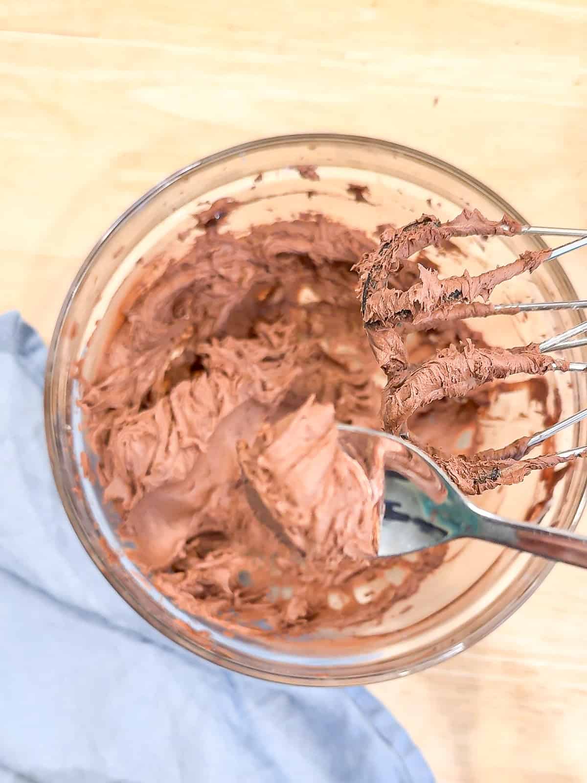 Chocolate buttercream in a glass bowl.