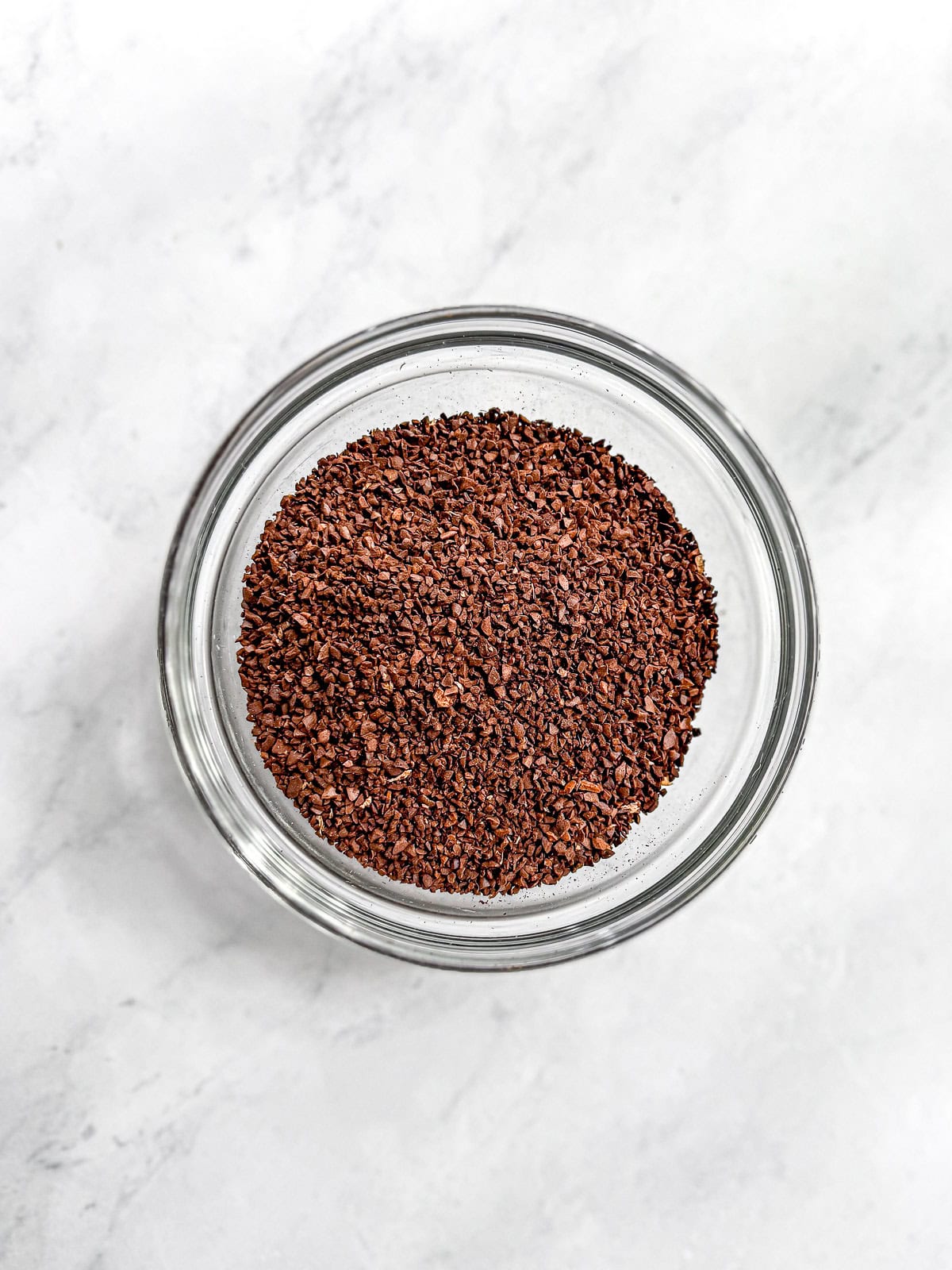 Course ground coffee in a glass bowl.