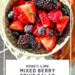 Pinterest image of a bowl of mixed berry fruit salad.
