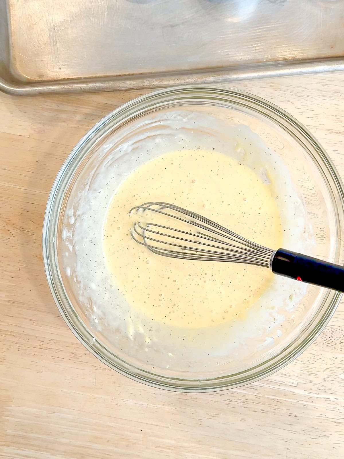 Donut wet ingredients in a glass bowl.