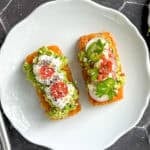 Various hash brown avocado toast on a white plate.