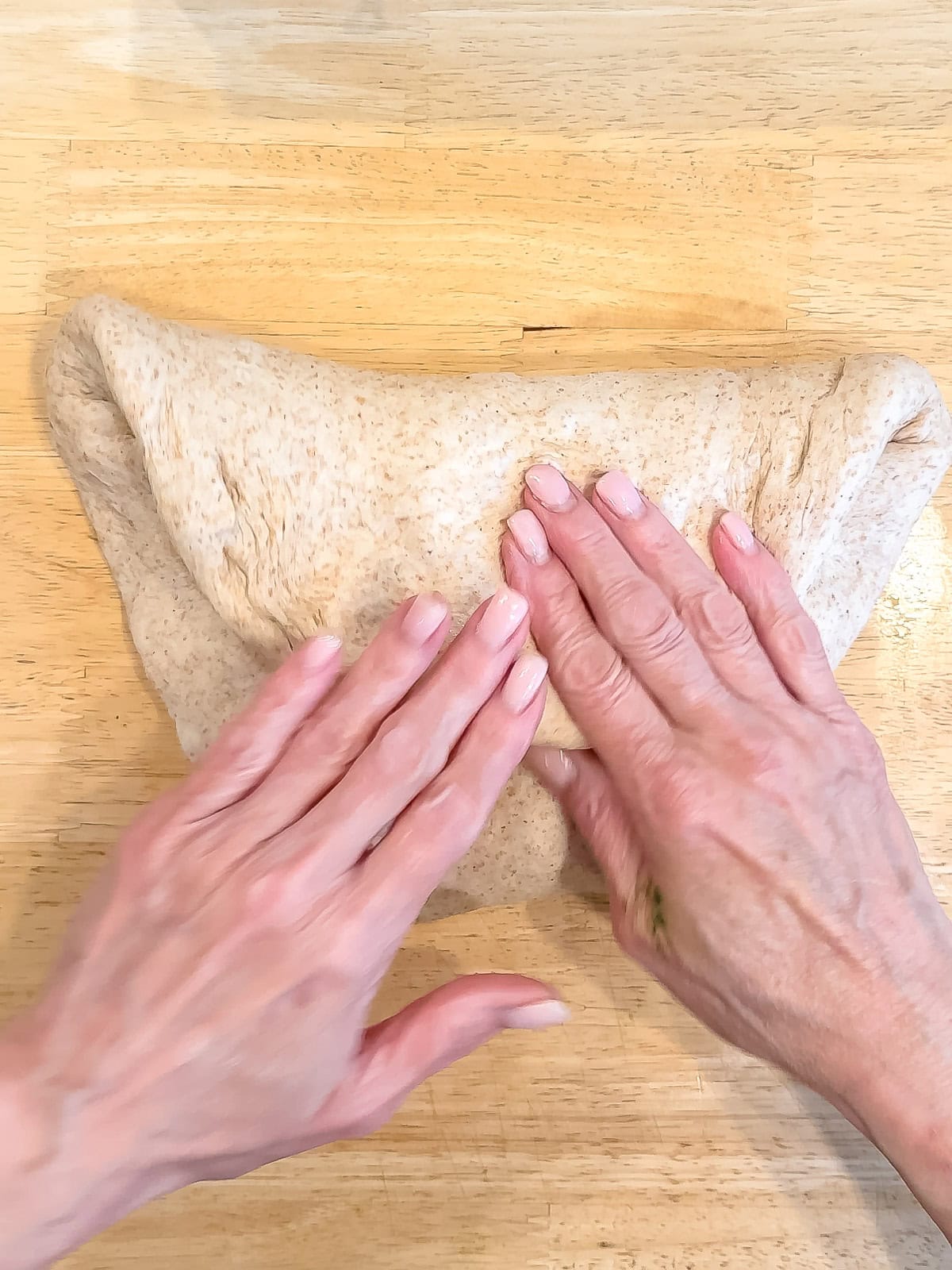 Forming a loaf of honey wheat bread.