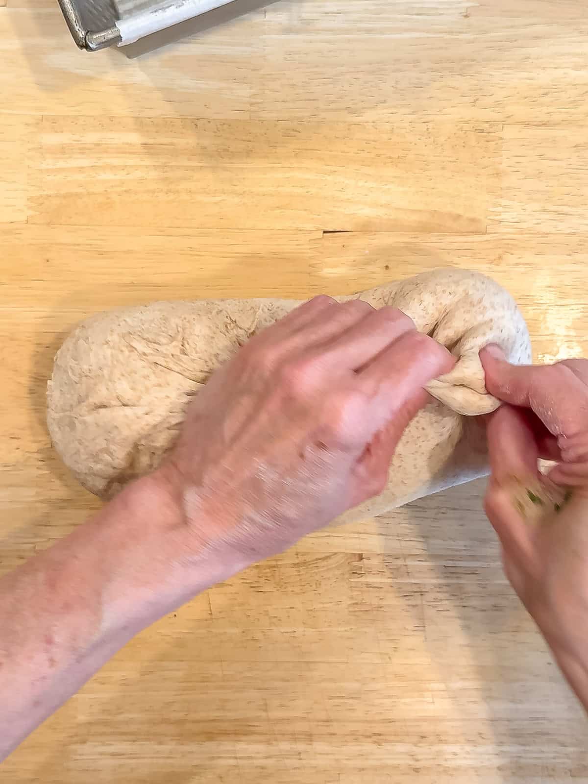 Forming a loaf of honey wheat bread.