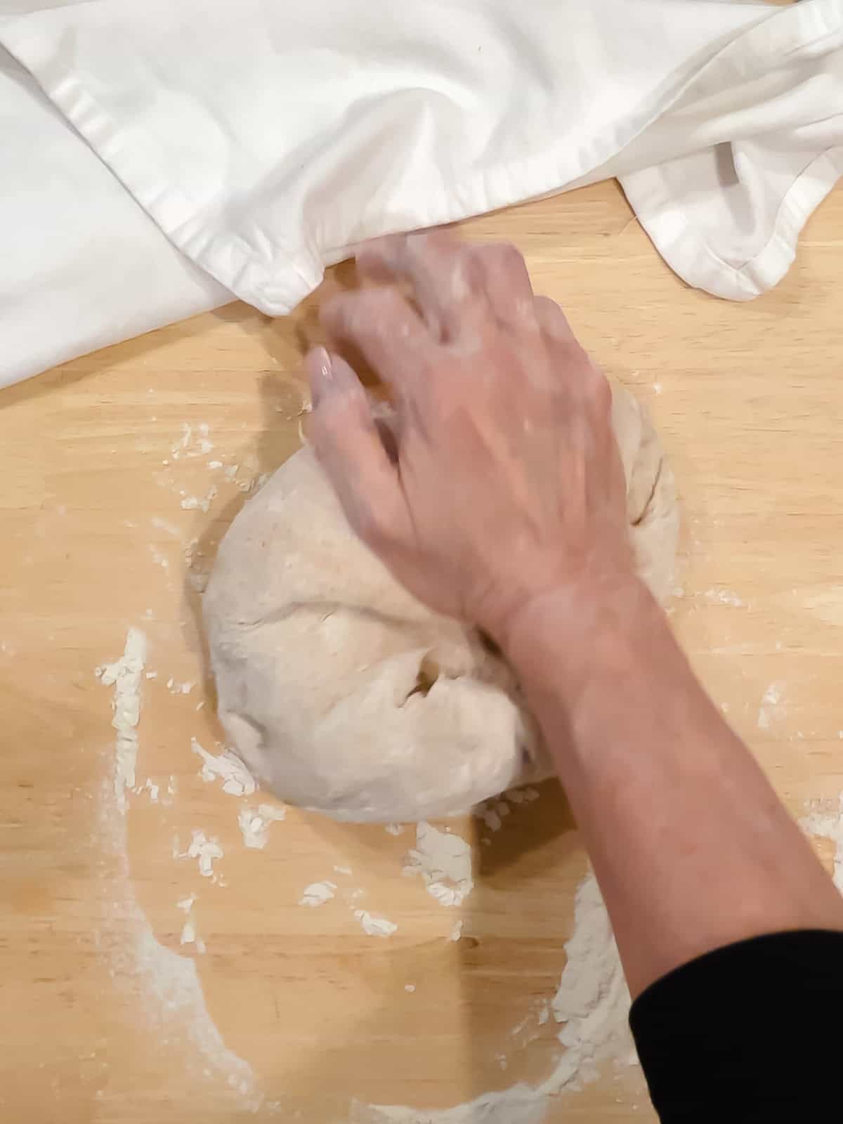 Hand kneading honey whole wheat dough.